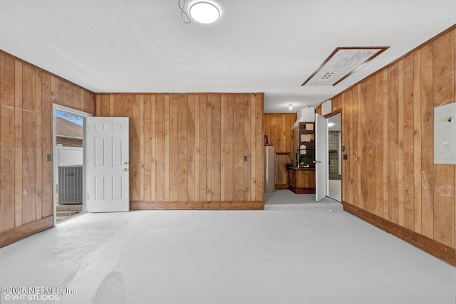 7927 Dwyer Dr, Jacksonville, FL 32244 - empty room featuring water heater, heating unit, wooden walls, and finished concrete floors