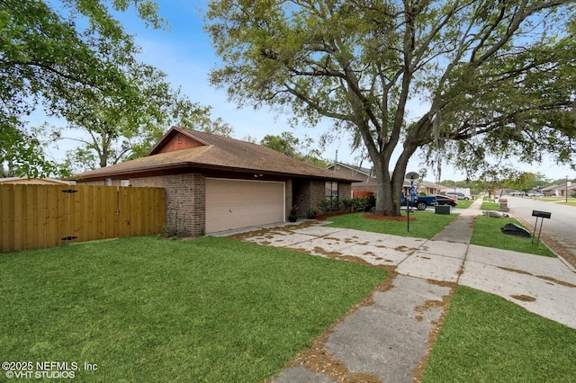 7927 Dwyer Dr, Jacksonville, FL 32244 - view of front of property with a front yard, concrete driveway, fence, brick siding, and a garage