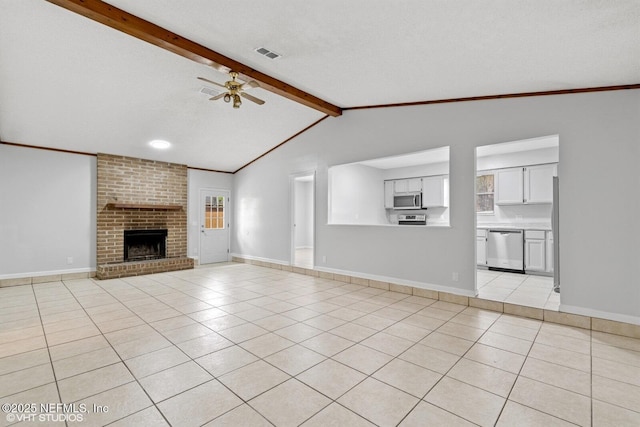 7927 Dwyer Dr, Jacksonville, FL 32244 - unfurnished living room with vaulted ceiling with beams, a textured ceiling, light tile patterned floors, visible vents, and ceiling fan