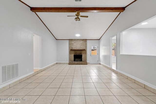 7927 Dwyer Dr, Jacksonville, FL 32244 - unfurnished living room featuring a ceiling fan, vaulted ceiling with beams, a fireplace, light tile patterned floors, and visible vents
