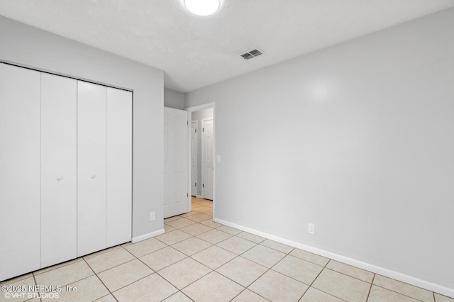 7927 Dwyer Dr, Jacksonville, FL 32244 - unfurnished bedroom featuring light tile patterned flooring, baseboards, a closet, and visible vents