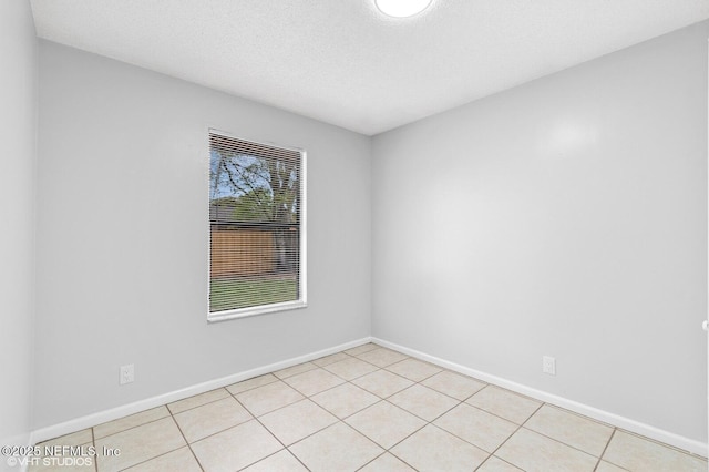 7927 Dwyer Dr, Jacksonville, FL 32244 - empty room with light tile patterned flooring, baseboards, and a textured ceiling