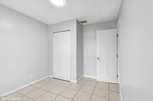 7927 Dwyer Dr, Jacksonville, FL 32244 - unfurnished bedroom with baseboards, visible vents, a closet, and light tile patterned floors
