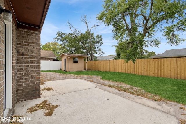 7927 Dwyer Dr, Jacksonville, FL 32244 - view of patio featuring a fenced backyard, an outdoor structure, and a storage shed