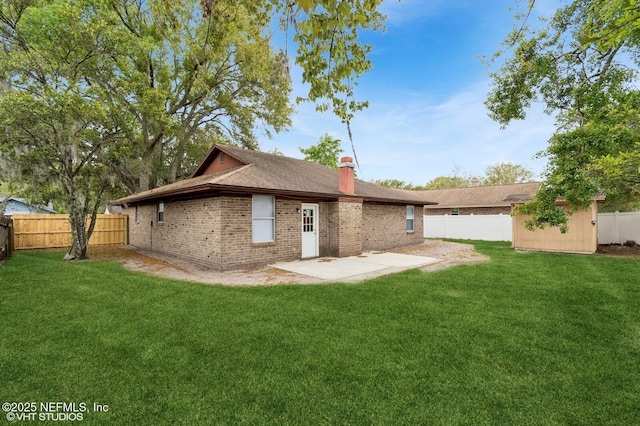 7927 Dwyer Dr, Jacksonville, FL 32244 - rear view of property featuring a fenced backyard, a lawn, an outbuilding, and a patio