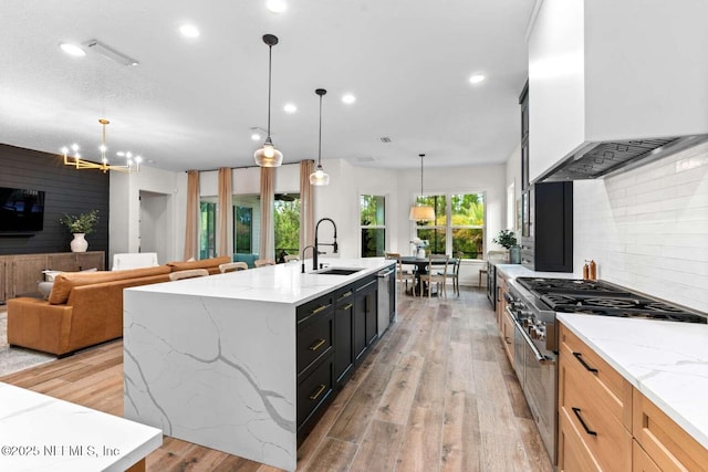 126 Seahill Dr, Saint Augustine, FL 32092 - kitchen featuring a sink, tasteful backsplash, wall chimney exhaust hood, stainless steel appliances, and light wood-style floors