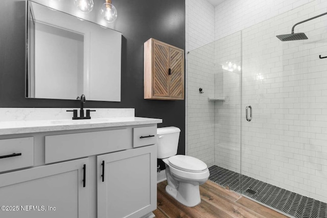126 Seahill Dr, Saint Augustine, FL 32092 - bathroom with toilet, a stall shower, vanity, and wood finished floors