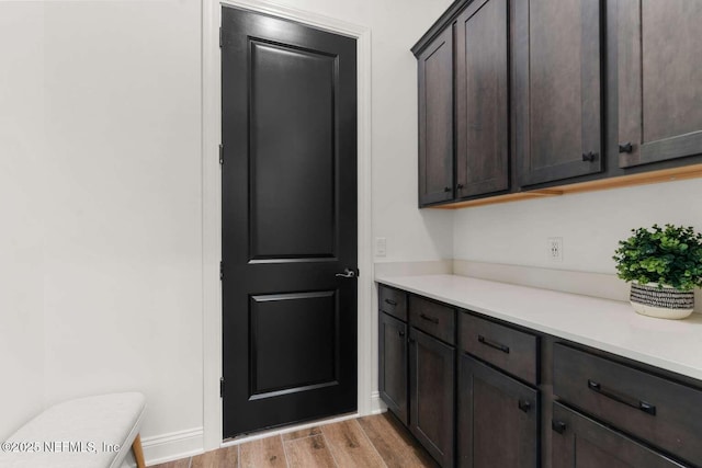 126 Seahill Dr, Saint Augustine, FL 32092 - interior space featuring light countertops, light wood-style flooring, and dark brown cabinets