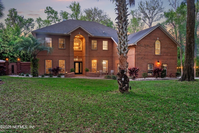 1053 Anchor Rd, Saint Johns, FL 32259 - back of house at dusk with a lawn and brick siding