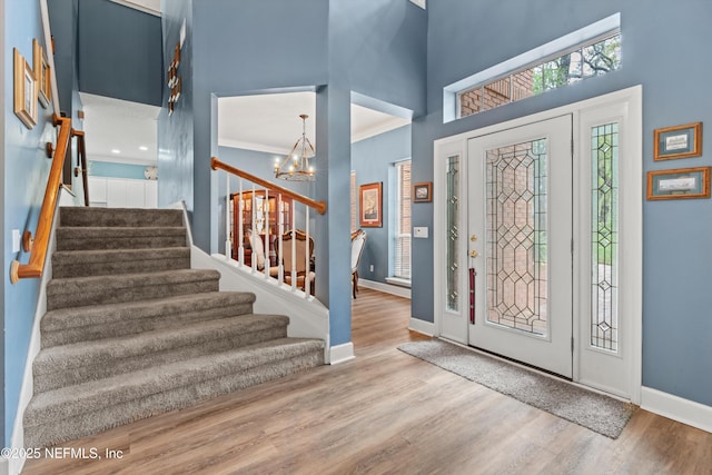 1053 Anchor Rd, Saint Johns, FL 32259 - foyer entrance with baseboards, wood finished floors, stairway, and a chandelier