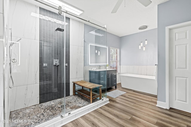 1053 Anchor Rd, Saint Johns, FL 32259 - bathroom with vanity, a shower stall, a soaking tub, a ceiling fan, and wood finished floors