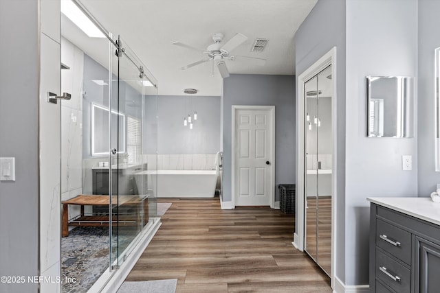 1053 Anchor Rd, Saint Johns, FL 32259 - bathroom featuring visible vents, wood finished floors, a ceiling fan, vanity, and a freestanding bath