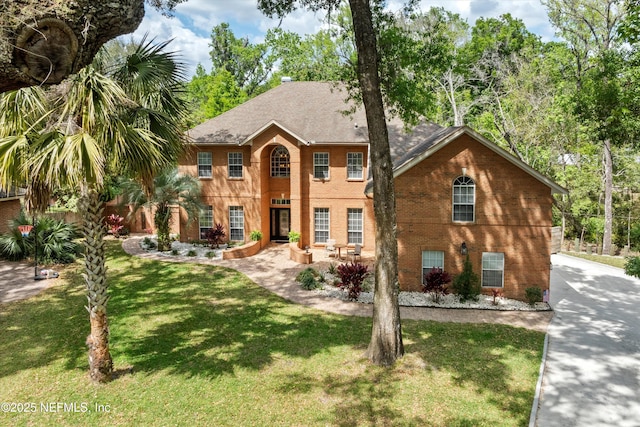 1053 Anchor Rd, Saint Johns, FL 32259 - view of front of house featuring a front lawn, brick siding, and concrete driveway