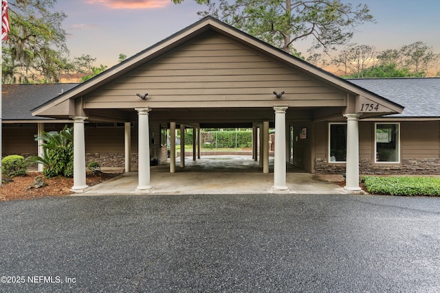 1053 Anchor Rd, Saint Johns, FL 32259 - view of front of property featuring stone siding, driveway, a carport, and roof with shingles