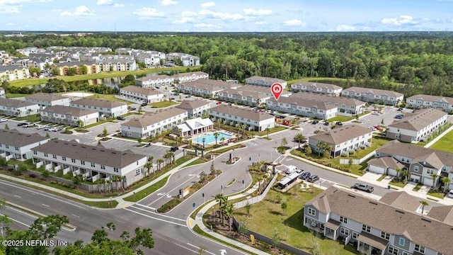 birds eye view of property featuring a residential view and a forest view