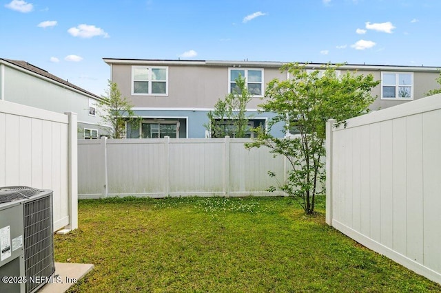view of yard with cooling unit and fence