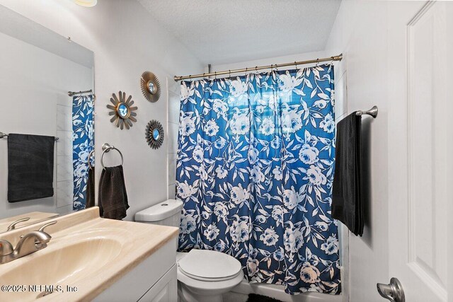1202 Wolfe St, Jacksonville, FL 32205 - full bathroom featuring toilet, a textured ceiling, vanity, and a shower with shower curtain