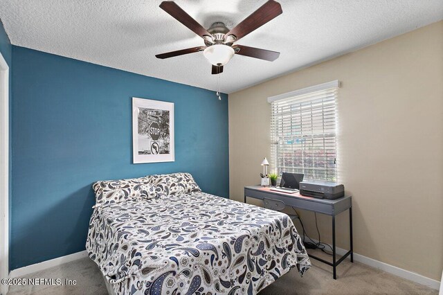 1202 Wolfe St, Jacksonville, FL 32205 - carpeted bedroom with baseboards, ceiling fan, and a textured ceiling