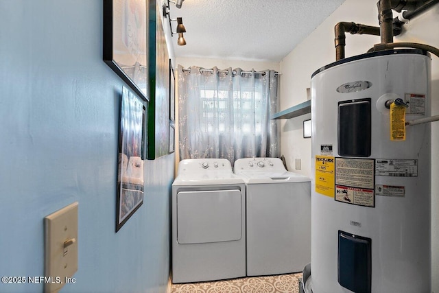 1202 Wolfe St, Jacksonville, FL 32205 - laundry room with water heater, washing machine and dryer, and a textured ceiling