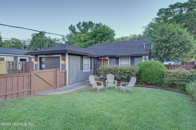 1202 Wolfe St, Jacksonville, FL 32205 - back of property featuring a shingled roof and a gate