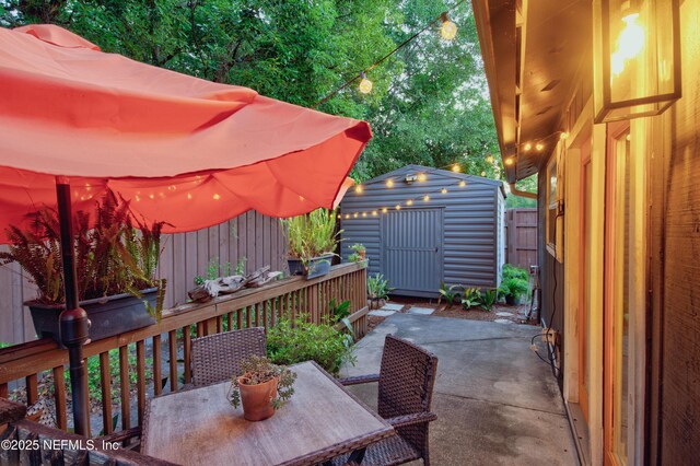 1202 Wolfe St, Jacksonville, FL 32205 - view of patio with outdoor dining area, a shed, an outdoor structure, and a fenced backyard