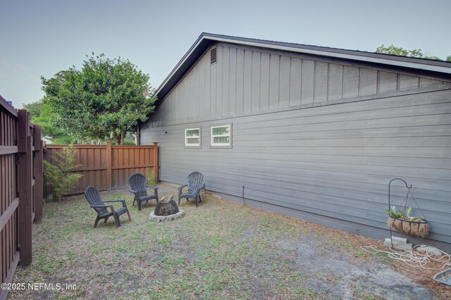 1202 Wolfe St, Jacksonville, FL 32205 - back of property featuring fence and an outdoor fire pit