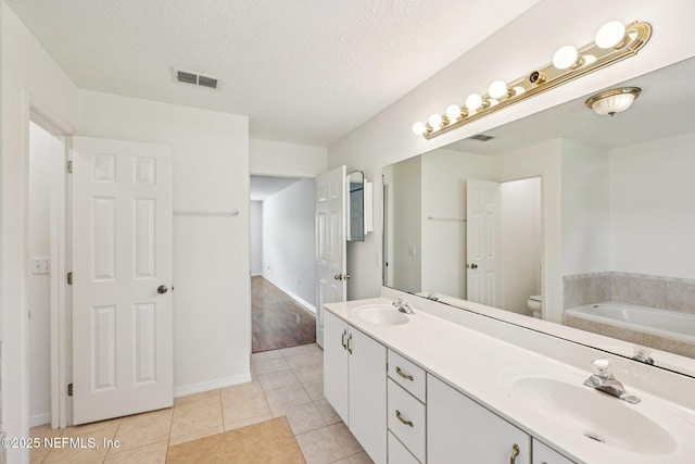 104 Seaside Cir, Ponte Vedra Beach, FL 32082 - full bath with a bath, double vanity, tile patterned flooring, toilet, and a textured ceiling