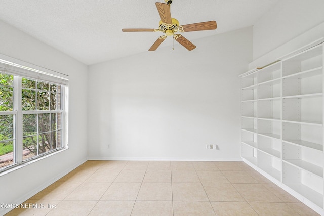 104 Seaside Cir, Ponte Vedra Beach, FL 32082 - spare room featuring vaulted ceiling, a ceiling fan, baseboards, light tile patterned flooring, and built in shelves