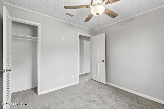 161 W 65th St, Jacksonville, FL 32208 - unfurnished bedroom featuring a closet, a textured ceiling, visible vents, carpet, and ornamental molding