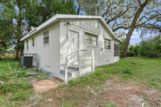 161 W 65th St, Jacksonville, FL 32208 - view of property exterior with central AC and a yard