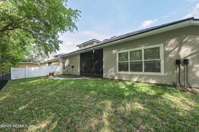 141 Casa Sevilla Ave, Saint Augustine, FL 32092 - rear view of property with a yard, fence, and stucco siding