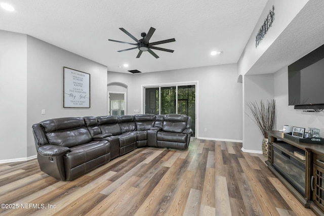 141 Casa Sevilla Ave, Saint Augustine, FL 32092 - living area with baseboards, a ceiling fan, arched walkways, and wood finished floors
