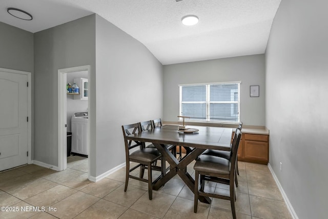 141 Casa Sevilla Ave, Saint Augustine, FL 32092 - dining area featuring a textured ceiling, light tile patterned floors, baseboards, and washer / dryer