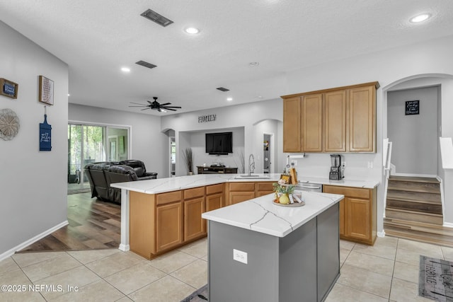 141 Casa Sevilla Ave, Saint Augustine, FL 32092 - kitchen with open floor plan, arched walkways, light tile patterned floors, and visible vents