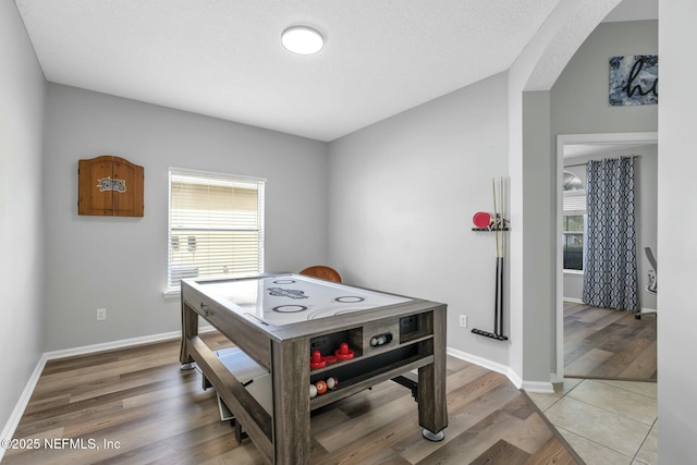 141 Casa Sevilla Ave, Saint Augustine, FL 32092 - game room featuring arched walkways, light wood finished floors, and baseboards