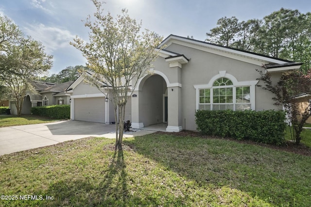 141 Casa Sevilla Ave, Saint Augustine, FL 32092 - view of front facade with an attached garage, driveway, stucco siding, and a front yard