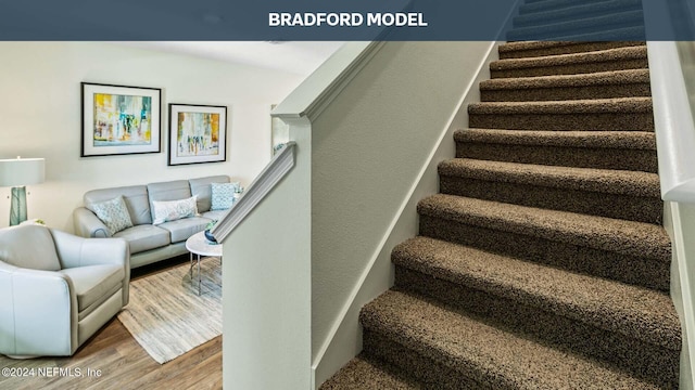 stairs featuring wood finished floors