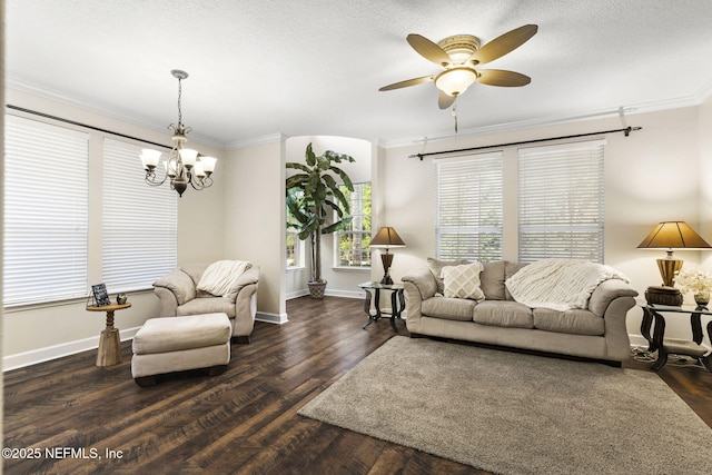 living area featuring crown molding, baseboards, a textured ceiling, wood finished floors, and ceiling fan with notable chandelier