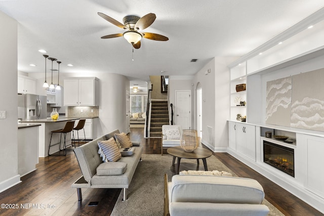 living area featuring dark wood-style floors, recessed lighting, ceiling fan, and visible vents