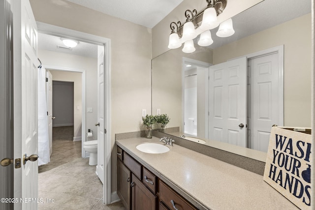 full bathroom with visible vents, baseboards, toilet, vanity, and tile patterned flooring