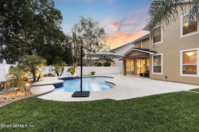 pool at dusk featuring a fenced in pool, a patio, a yard, and a fenced backyard