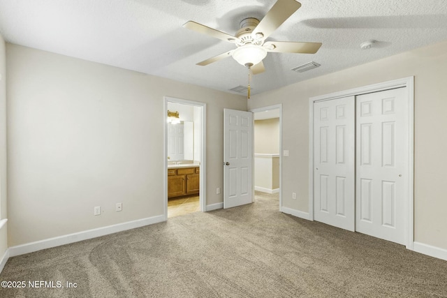 unfurnished bedroom with baseboards, visible vents, light carpet, and a closet