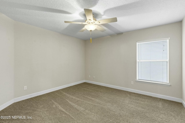 carpeted empty room featuring baseboards, a ceiling fan, and a textured ceiling