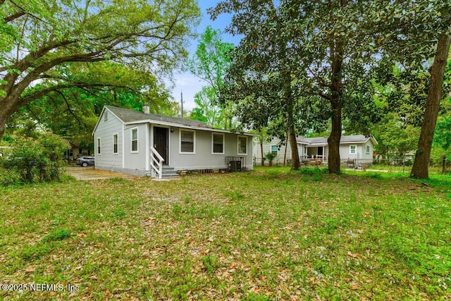 3051 4th Street Cir, Jacksonville, FL 32254 - rear view of house featuring entry steps, fence, central AC, and a yard