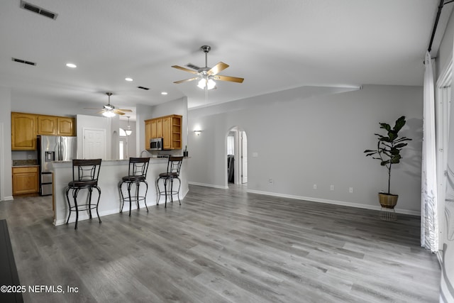 96086 Sea Winds Dr, Fernandina Beach, FL 32034 - kitchen with stainless steel appliances, arched walkways, ceiling fan, open shelves, and recessed lighting