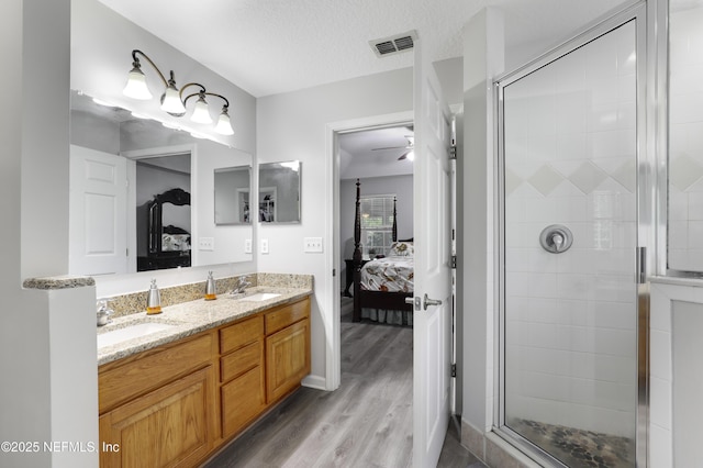 96086 Sea Winds Dr, Fernandina Beach, FL 32034 - bathroom with ensuite bathroom, a shower stall, wood finished floors, double vanity, and a ceiling fan