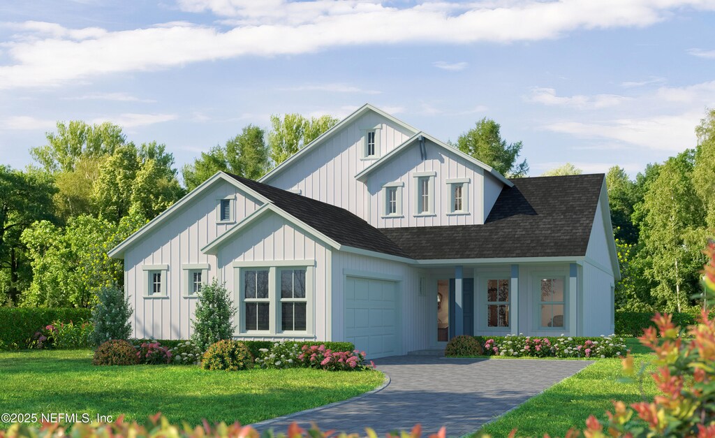 modern inspired farmhouse with decorative driveway, an attached garage, a front lawn, board and batten siding, and roof with shingles