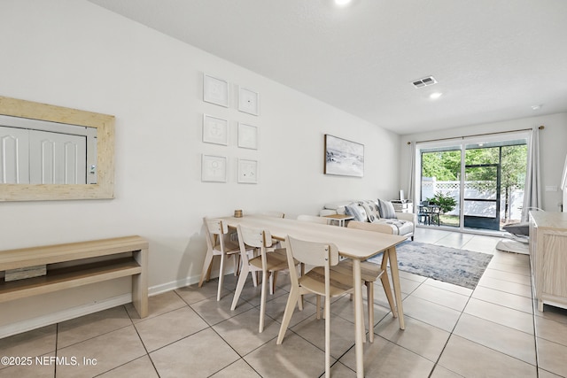 dining room featuring baseboards, visible vents, and tile patterned flooring
