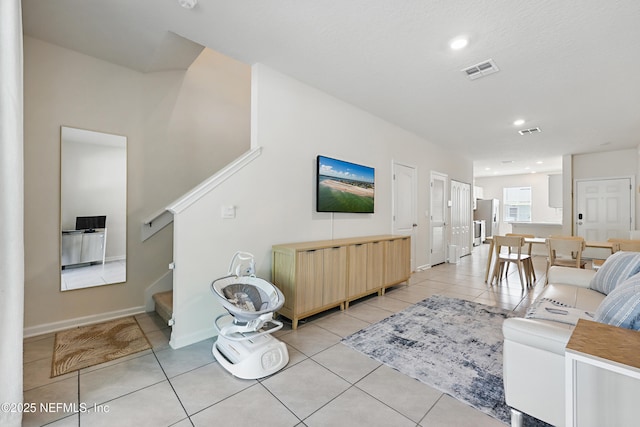 living room featuring recessed lighting, light tile patterned flooring, baseboards, and visible vents