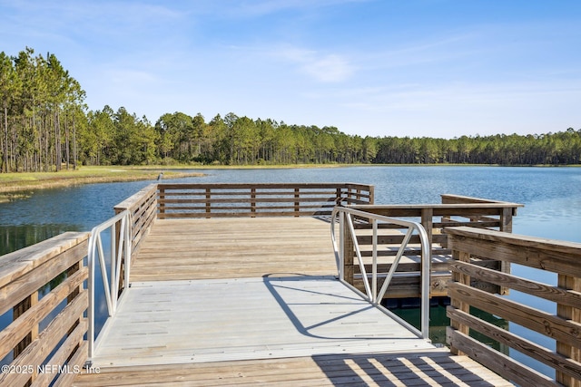 dock area featuring a water view and a wooded view